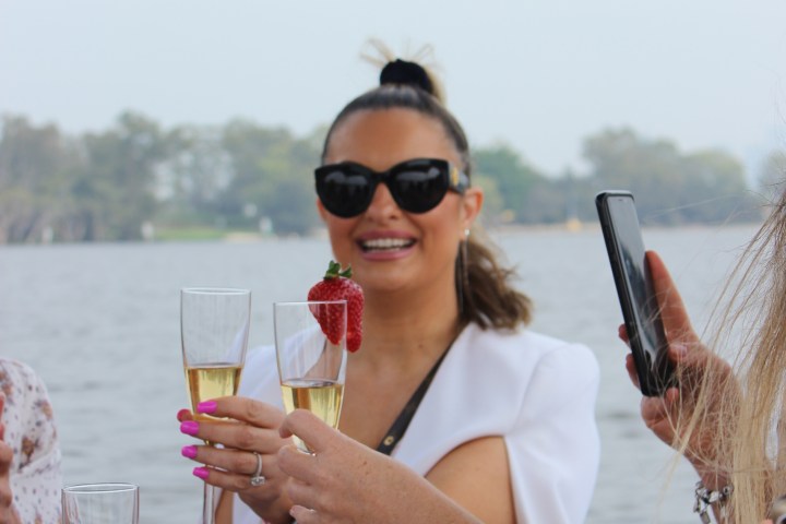 a person drinking water from a wine glass