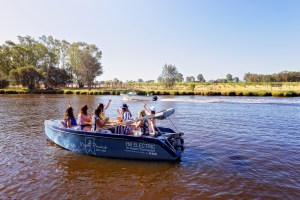 a group of people in a small boat in a body of water