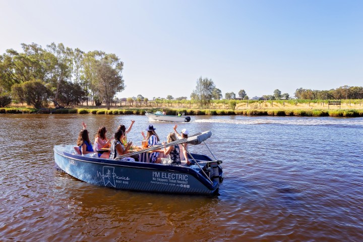 a group of people in a small boat in a body of water