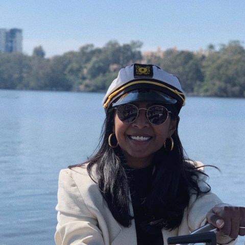a woman sitting on a boat in a body of water