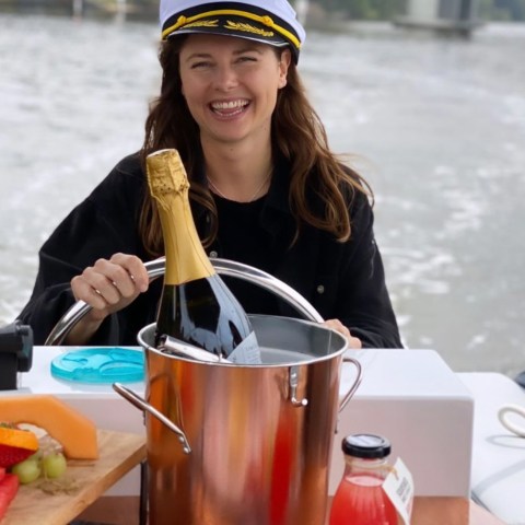 a person sitting at a table with a cup of water