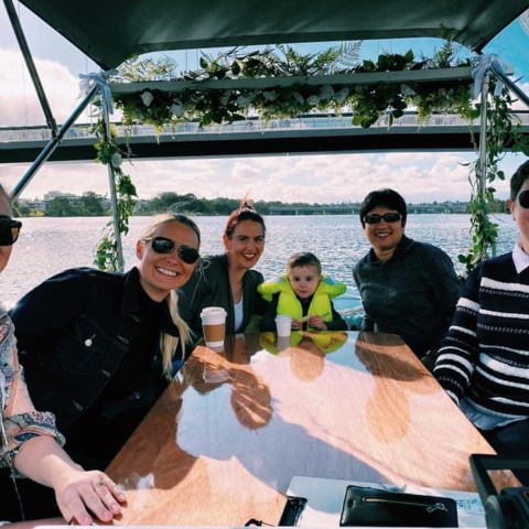 a group of people sitting on a boat