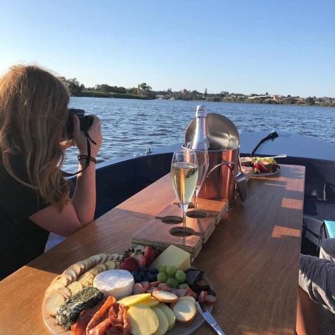 a woman drinking water from a boat