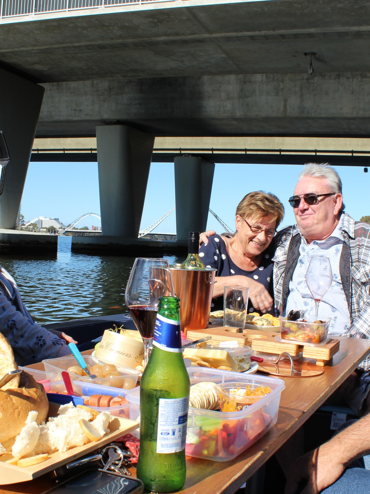 a group of people sitting at a table with food