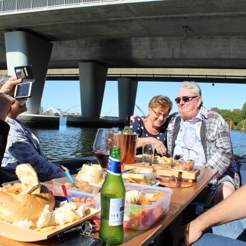 a group of people sitting at a table with food