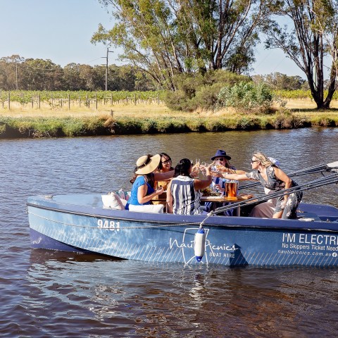 a group of people riding on the back of a boat in the water