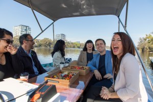 a group of people sitting at a picnic table posing for the camera