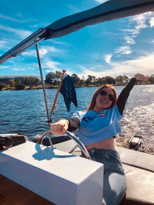 lady thrilled over driving a boat