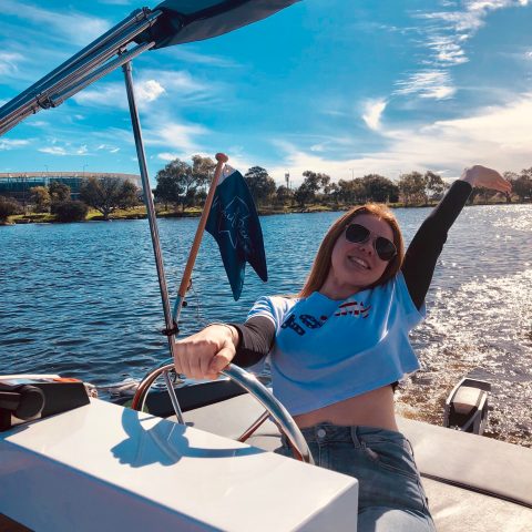 lady thrilled over driving a boat