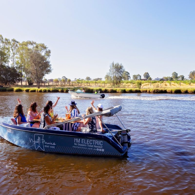 a group of people in a small boat in a body of water