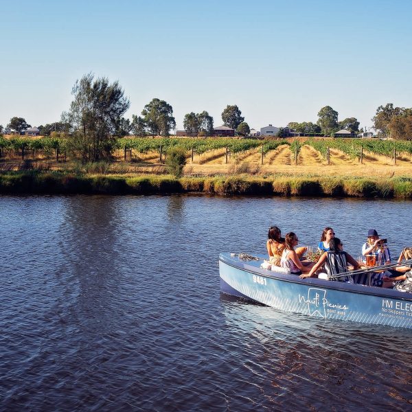 a group of people in a small boat on a Swan river in Perth