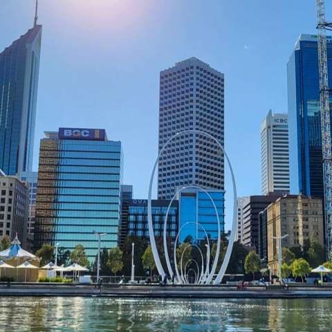 a large body of water with a city in the background