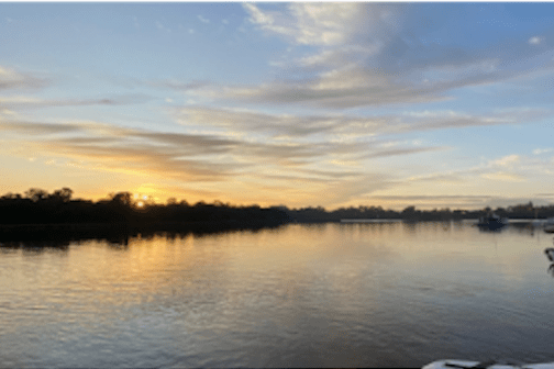 a boat is docked next to a body of water