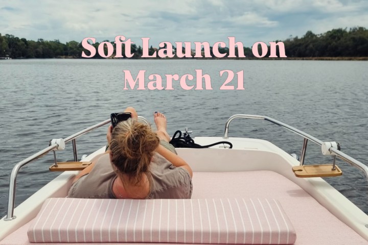 Person reclining on boat with 'Soft Launch on March 21' text overlay.