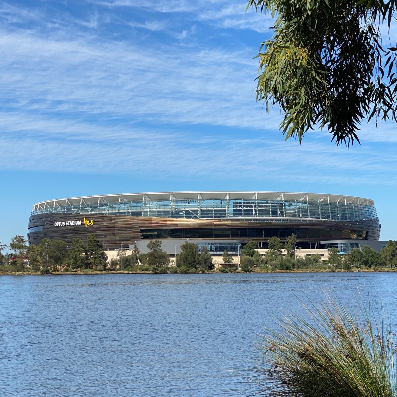 a large stadium on the rivers edge