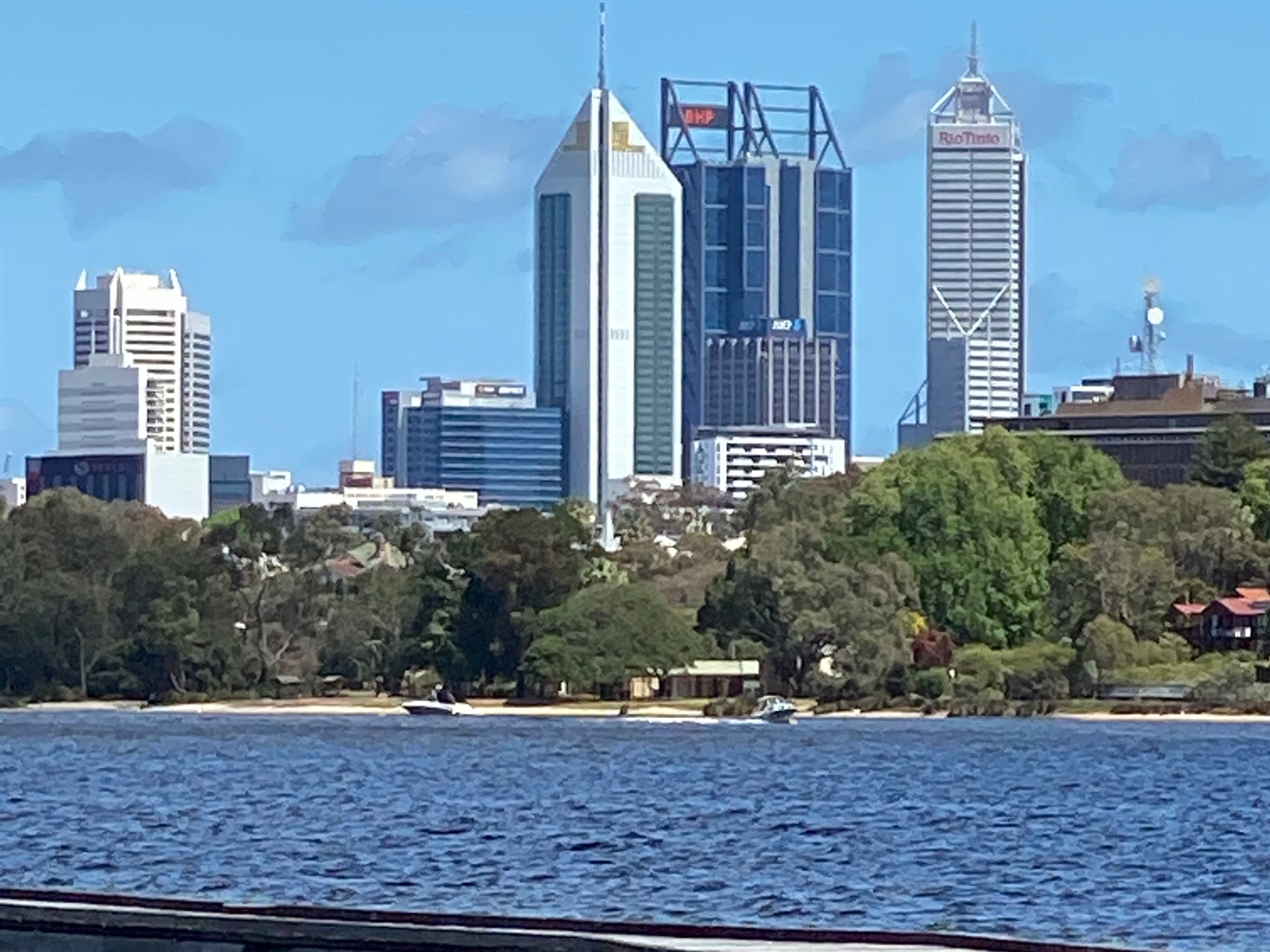 a bridge over a body of water with a city in the background